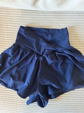 Navy crossover Ruffle Shorts. Built in compression shorts with pockets.